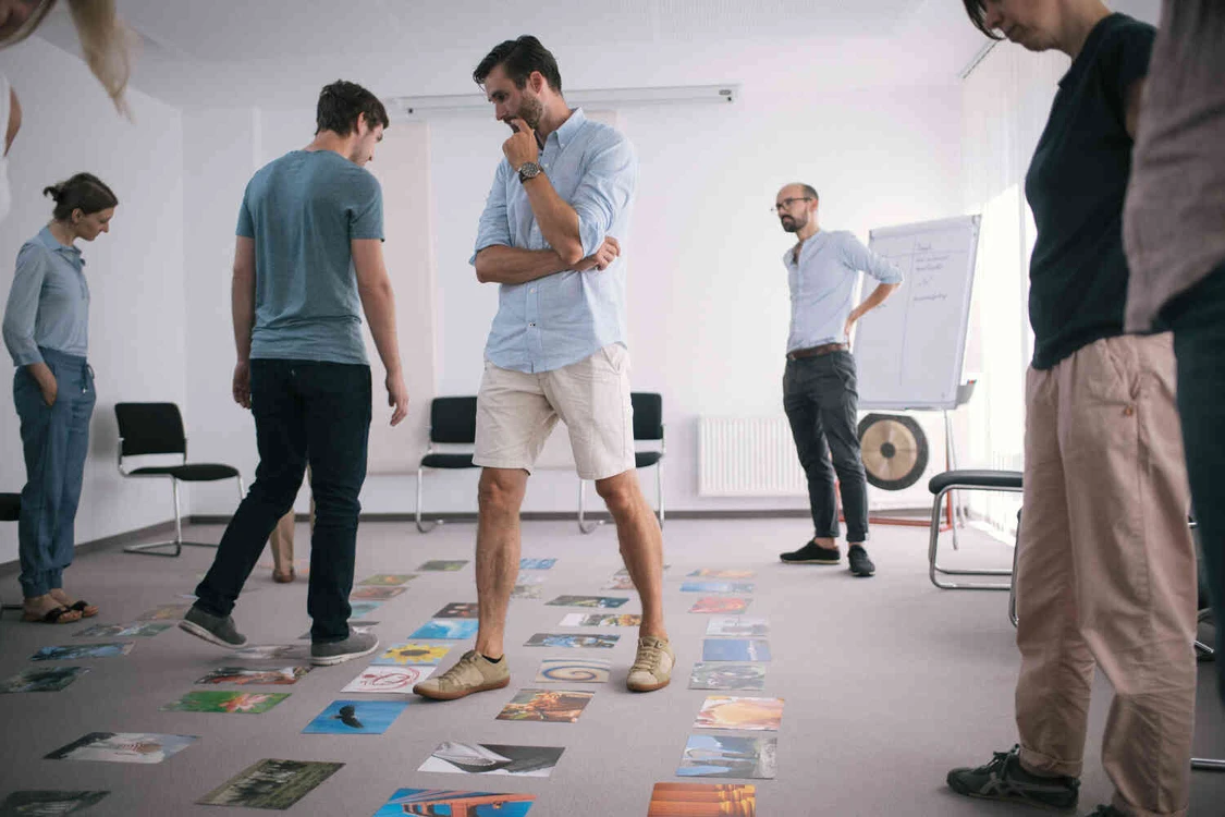 Mann steht in einem Raum voller bilder auf dem Boden