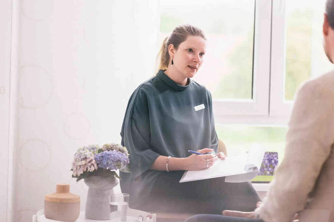 Frau spricht mit einem patienten